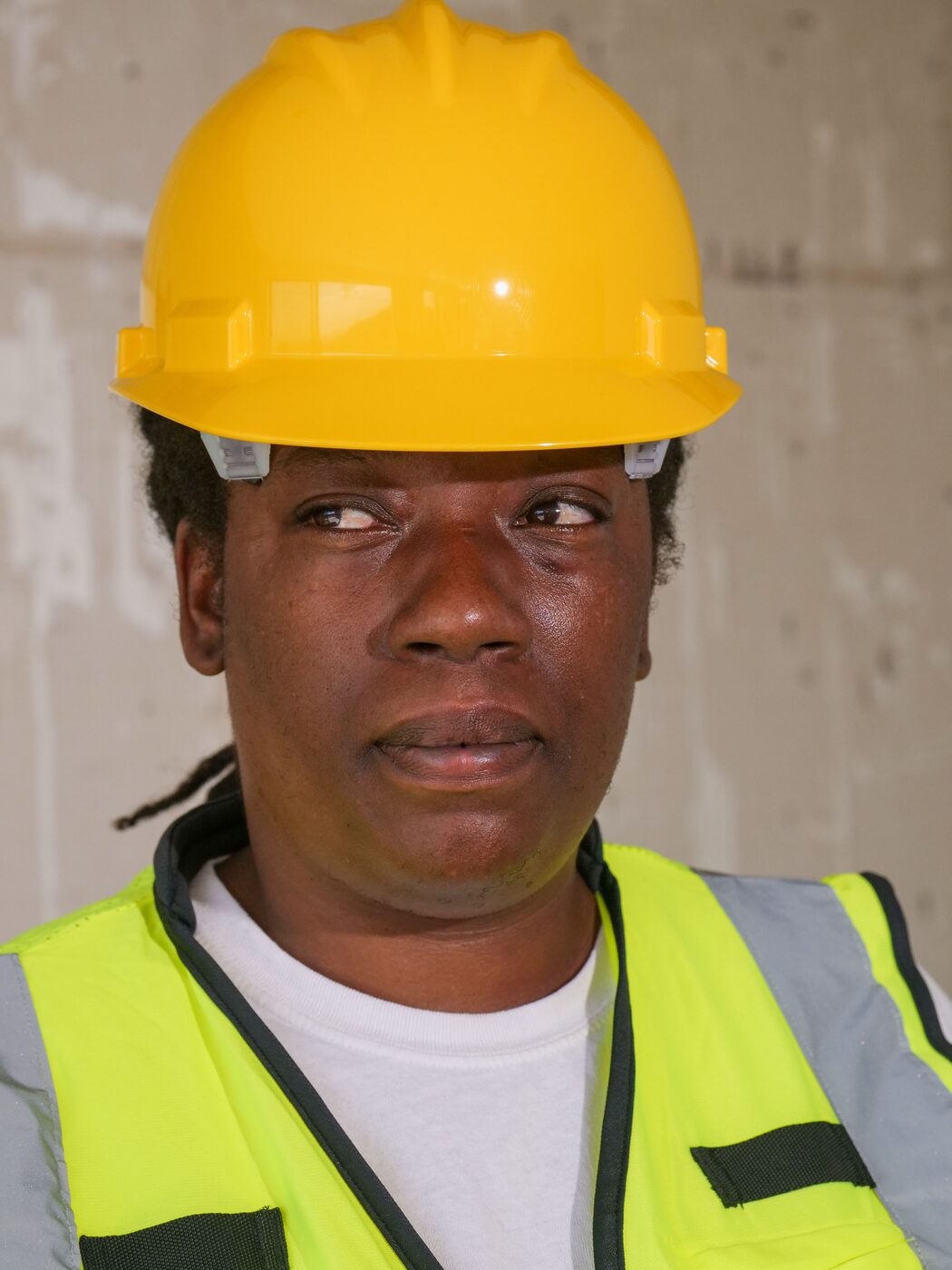 Black field engineer wearing safety equipment at a project site